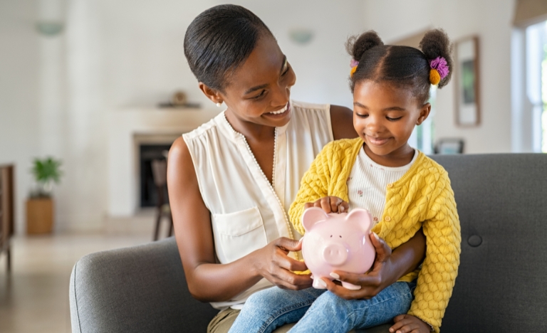 Woman and child with a piggy bank